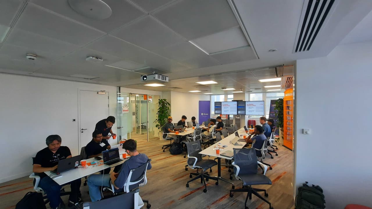 Builders at work in the Alibaba Cloud London office during the Superlinked x Qwen hackathon