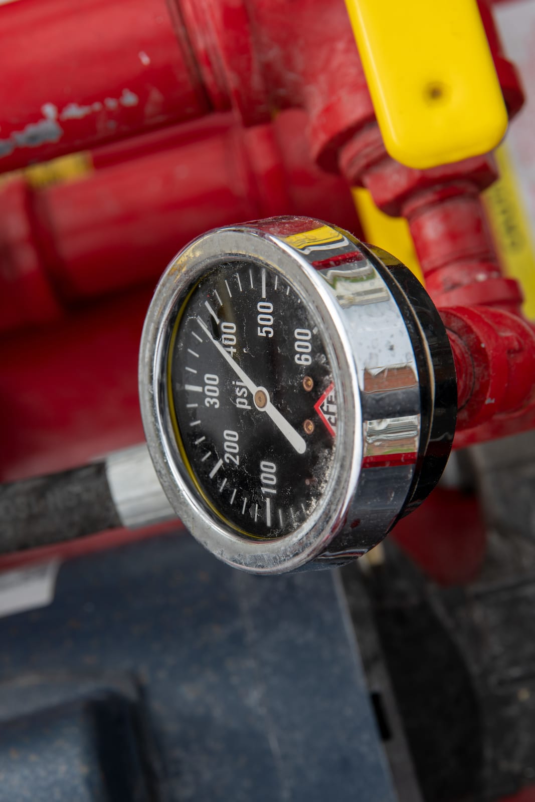 Pressure gauge on fire hose test equipment with a needle over a psi scale