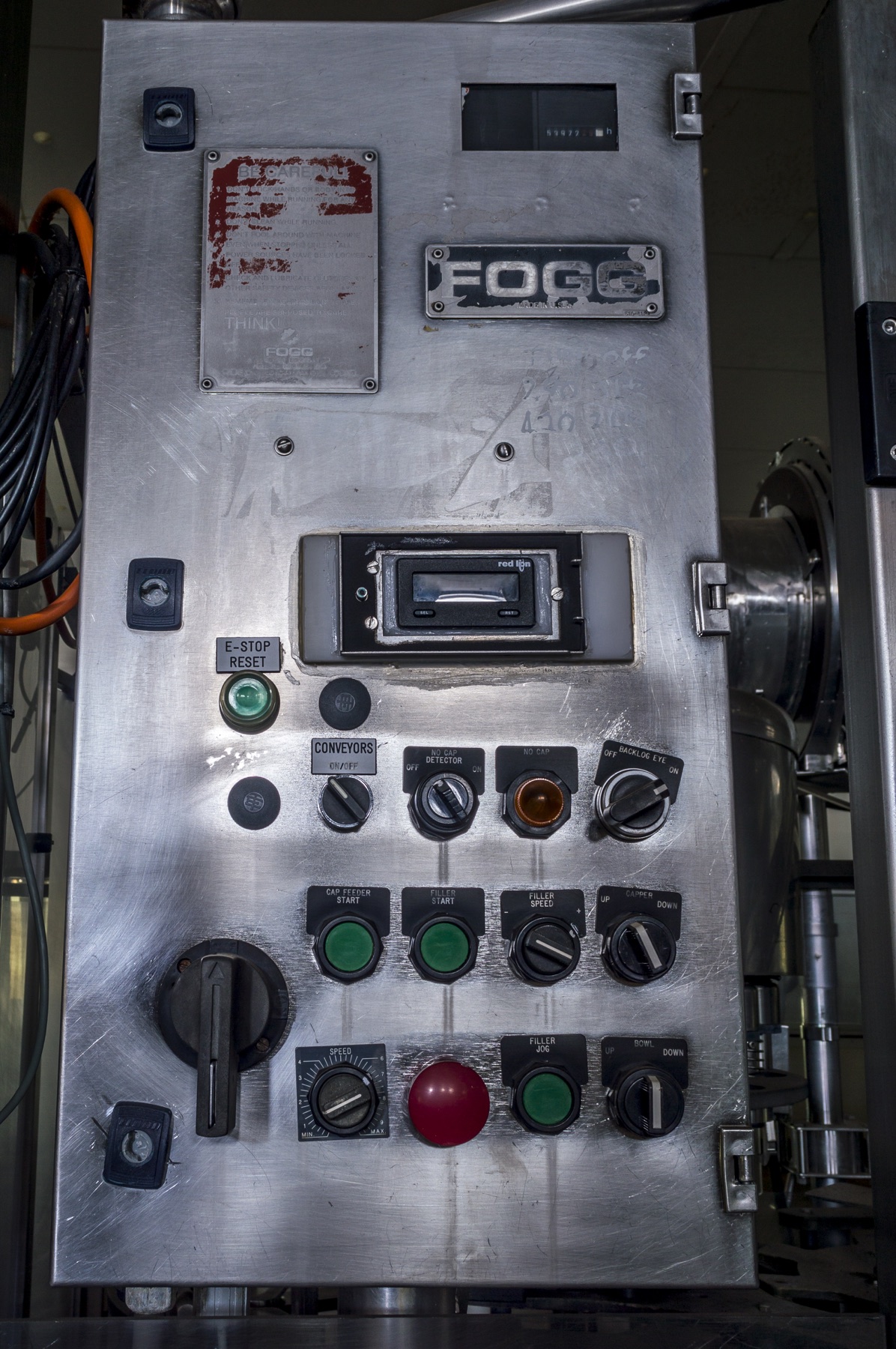 Worn factory control panel with operational labels